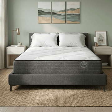 Gray Mattress Makers mattress on a bed in a bedroom with decorative elements.