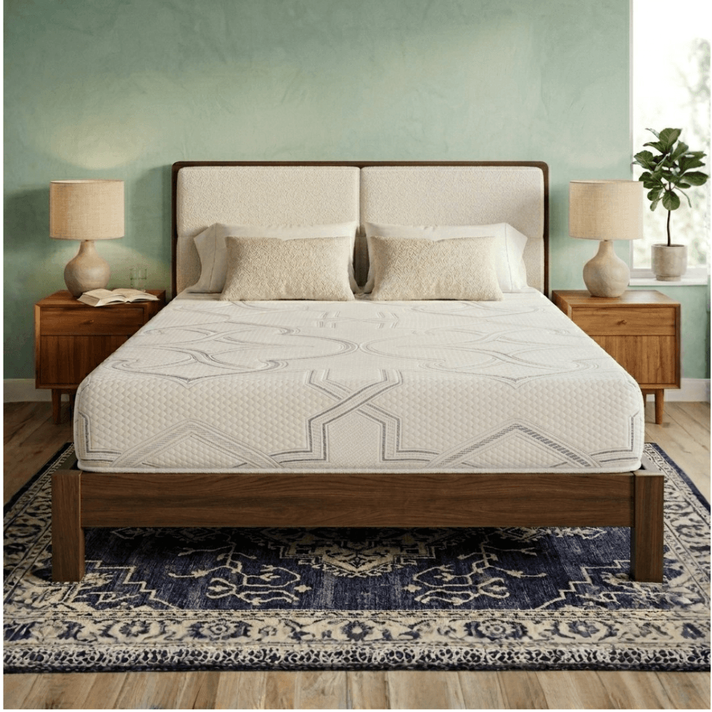 Bedroom with a Mattress Makers mattress on a wooden bed, nightstands, and lamps against a green wall.