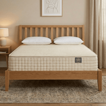 Wooden bed with beige Mattress Makers mattress in a bedroom setting