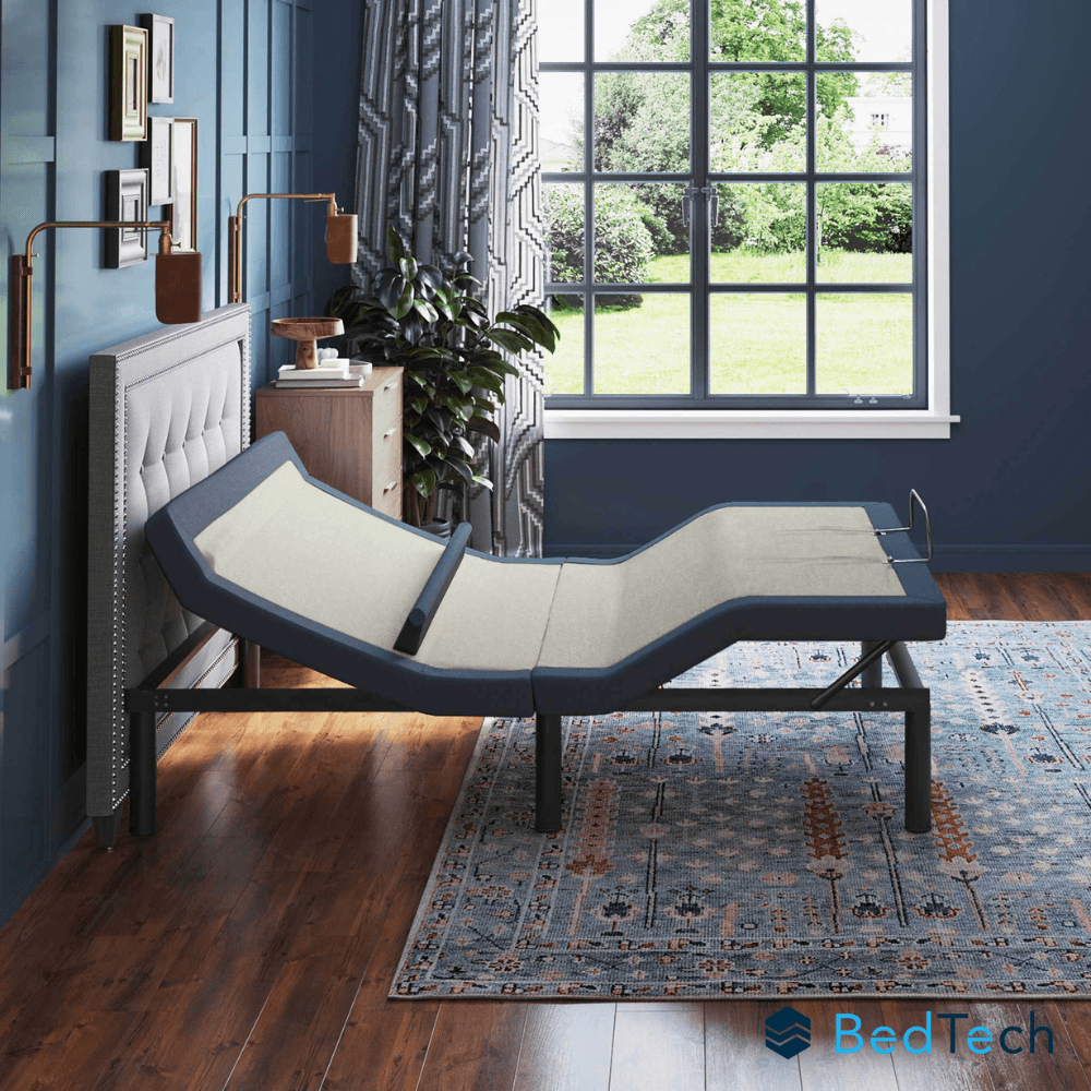 BedTech adjustable bed in a bedroom setting with blue walls and a large window.