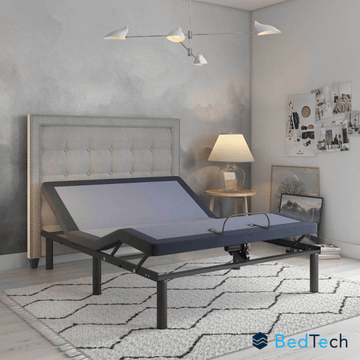 BedTech adjustable bed in a bedroom setting with a gray headboard and decor.