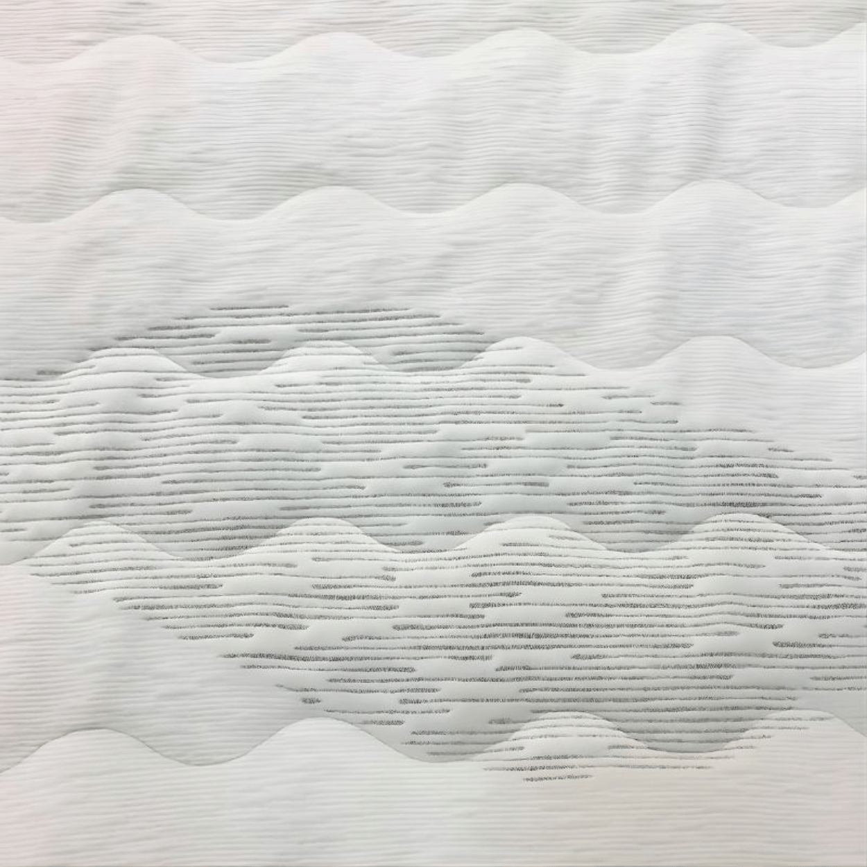 Textured white mattress surface with wavy pattern